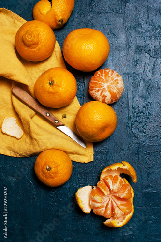 Fresh ripe mandarins on the textured navy blue table