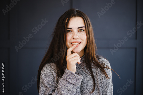 Adorable young woman looking on camera and smiling. Emotions, feelings and face expression