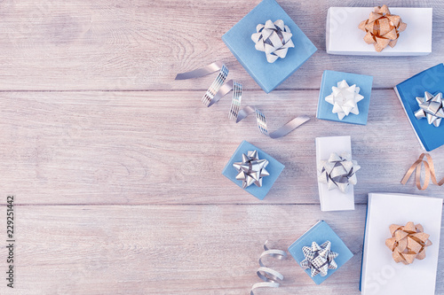 White and blue gift boxes with beautiful bows, decorative ribbons. Christmas composition with place for text, copy space.