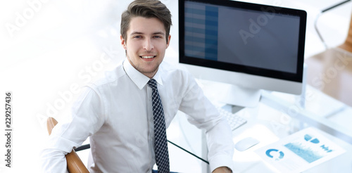 employee sitting in front of a computer screen