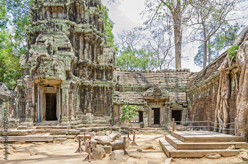 Photos Ruins of temples of Angkor Thom with roots of a spung running along the gallery