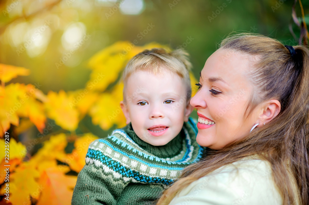 happy mother with her little son goulabt in autumn park at sunset happy mother with her little son goulabt in autumn park at sunset