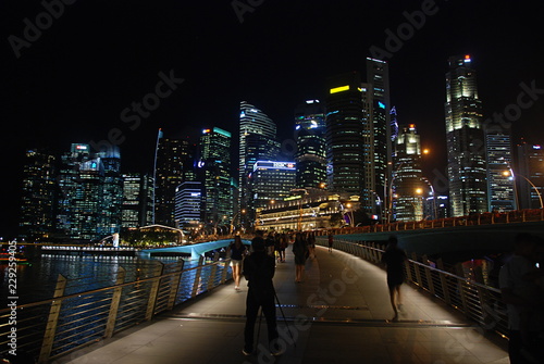 Modern architecture around Marina Bay in Singapore city centre illuminated at night
