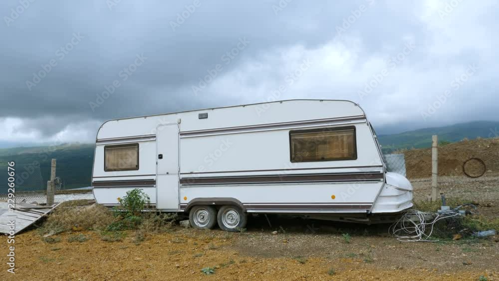 Lonely old caravan high in the mountains. Cloudy rainy weather. Lonely old caravan high in the mountains. Cloudy rainy weather.