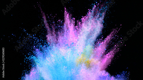 Multi-color powder explosion on black background photo