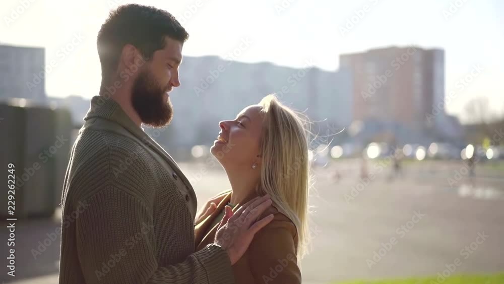 Side view shot of a beautiful happy couple looking at eact other and smiling, smiles on faces. Side view shot of a beautiful happy couple looking at eact other and smiling, smiles on faces.