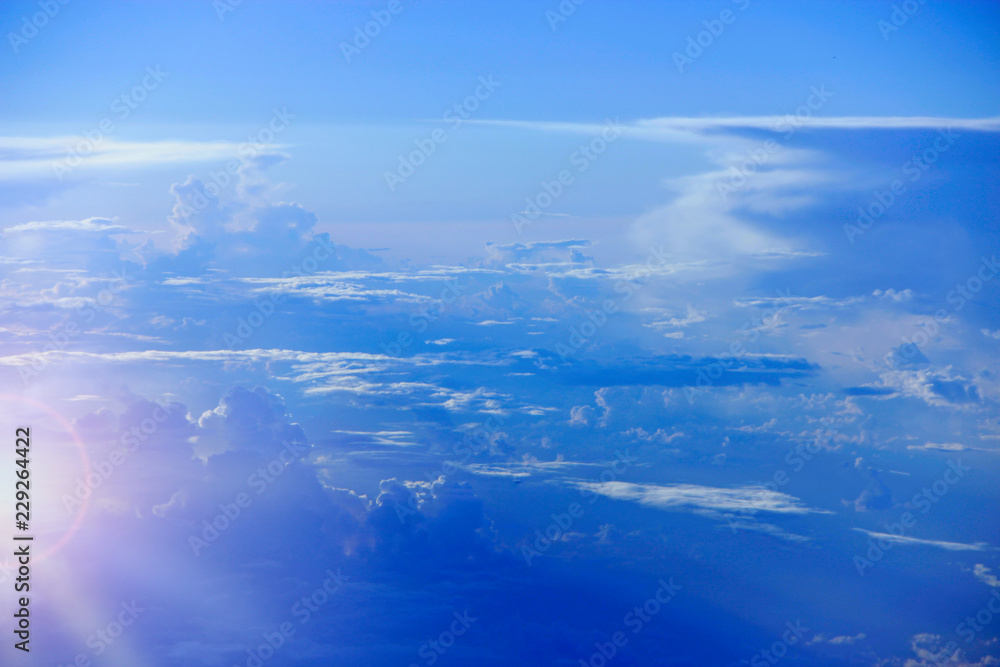 Beautiful white clouds with sunny rays. Landscape with sun and sky