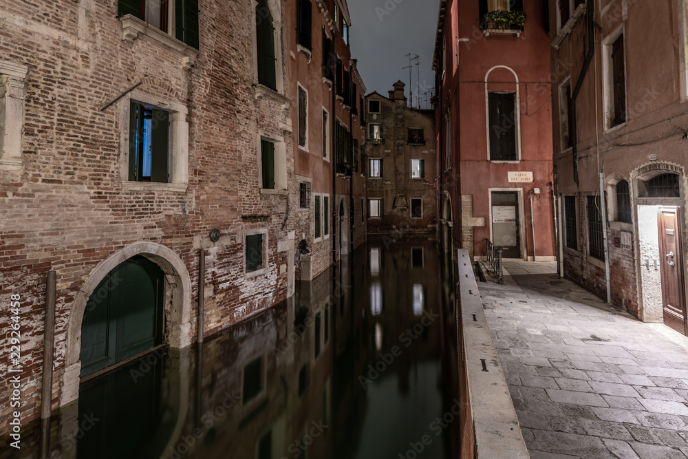 A medieval canal in Venice with beautiful reflections