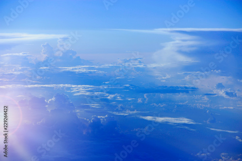 Beautiful white clouds with sunny rays. Landscape with sun and sky