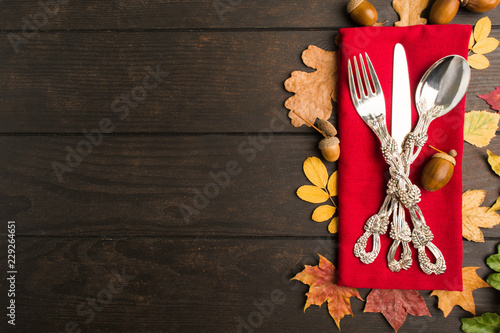 Autumn thanksgiving table with tableware and red napkin