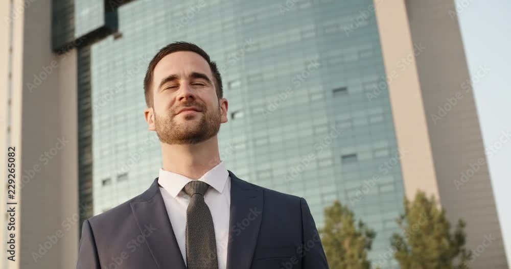 Confident businessman in suit and tie looking around, waiting for someone in city centre - closeup 4k Confident businessman in suit and tie looking around, waiting for someone in city centre - closeup 4k