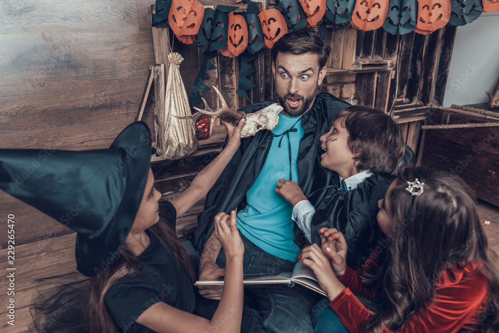 Man and Children in Halloween Costumes having Fun