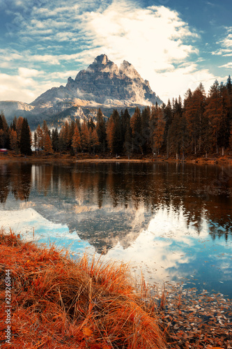 Famous Tre Cime di Lavaredo (Drei Zinnen) reflection on Antorno lake dring late autumn. Italy, Europe