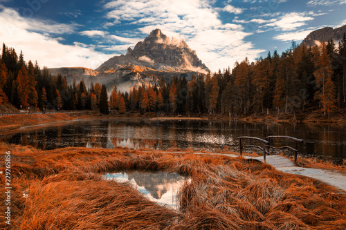 Late autumn wih red colors at Antorno lake with beautiful Tre Cime di Lavaredo mountain reflection. Italy, Europe