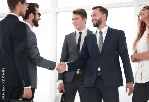 handshake trading partners in a modern office © ASDF