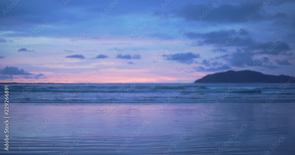 Out of focus background plate of purple and blue sunset on Costa Rica beach