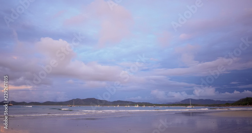 Ocean at sunset in Costa Rica filled with small boats anchored off shore © rocketclips