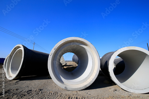 Many cement pipes are at the construction site
