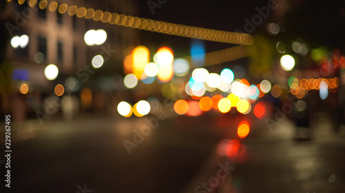 Photos Blurry background plate of city traffic at night with bokeh headlights passing