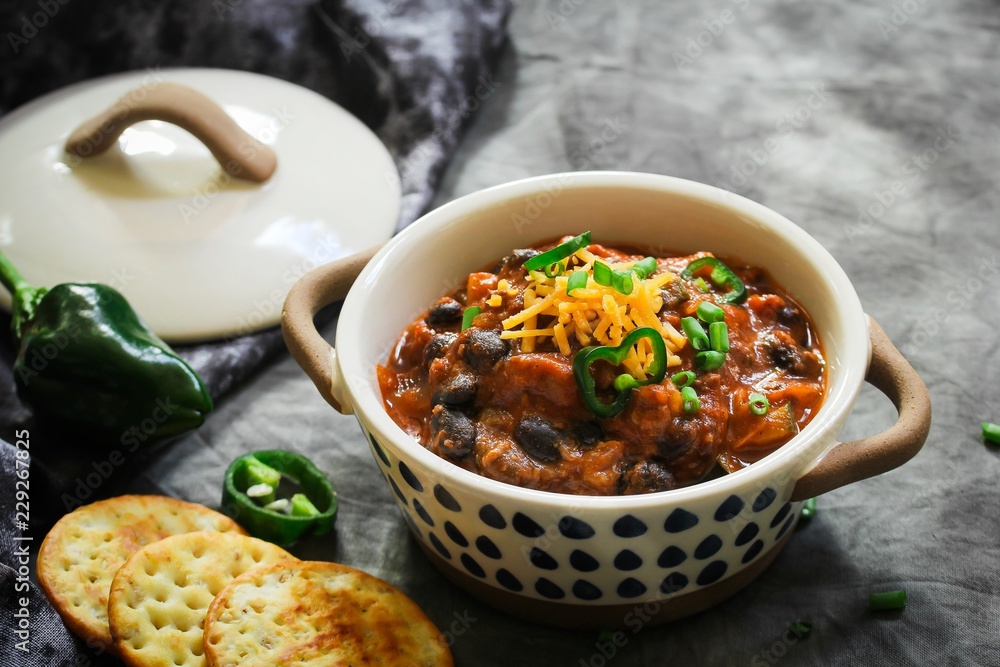 Homemade Black beans Beef Chili topped with cheddar cheese and green onions Homemade Black beans Beef Chili topped with cheddar cheese and green onions