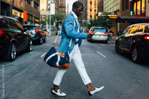 Wallpaper Mural Young businessman walking in the street in New York City Torontodigital.ca