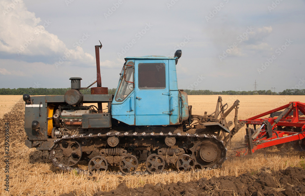 Fototapeta premium Tractor preparing land for sowing