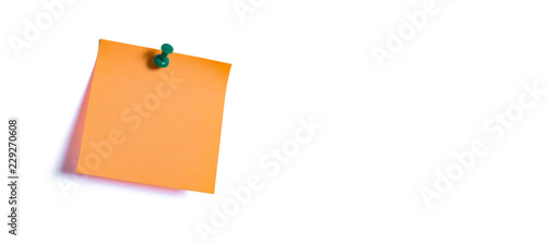 orange note paper fastened to the wall