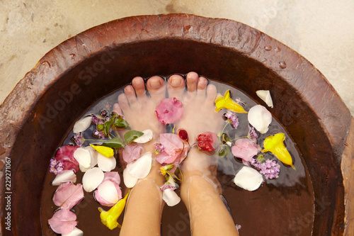 Hispanic woman receiving a foot massage and pedicure at luxury spa photo