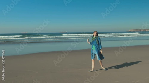 Beautiful girl on the relaxing in the blue spacious ocean beach