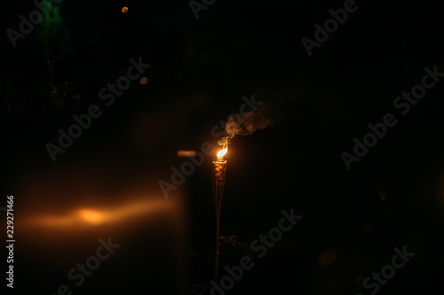 Burning Tiki torch at night