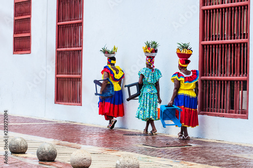 Photography Traditional fruit street vendors in Cartagena de Indias called Palenqueras walki