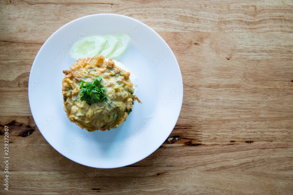 Traditional Thai style, Omelet on Jasmine Rice on Brown Cloth Background.Omelet with Rice, Thai Food, This Cuisine,Thai easy lunch