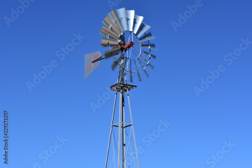 old windmill against blue sky