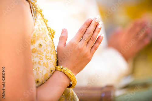 Fényképezés Beautiful Asian girl to pay respect and praying Buddhism worshiping Buddha statue with faith