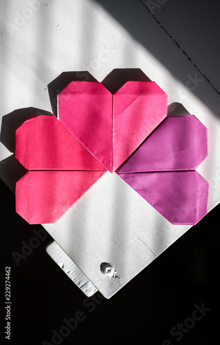 Origami hearts sitting on the corner of a desk photo