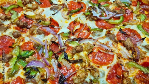 Pizza toppings variety closeup directly above full frame image.