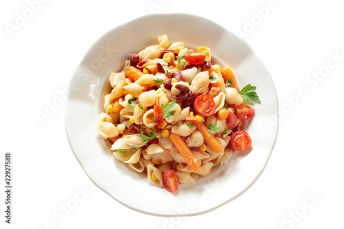 Vegetarian vegetable pasta. Pasta shells with tomato, baby carrot, paprika, beans, sweet corn and chickpea.
 Isolated on white background.  Top view.
