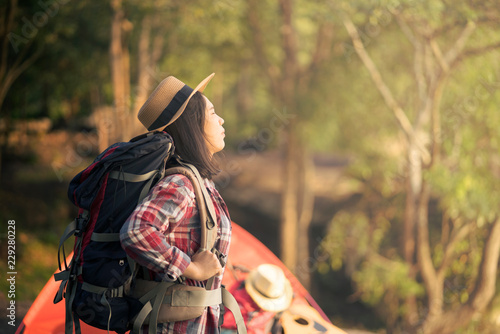 Backpacker woman standing with sunlight