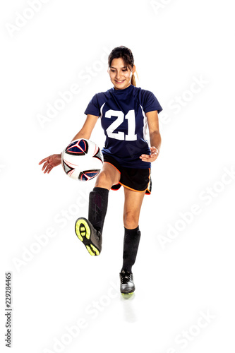 Female Latina Soccer Player KIcking a Ball