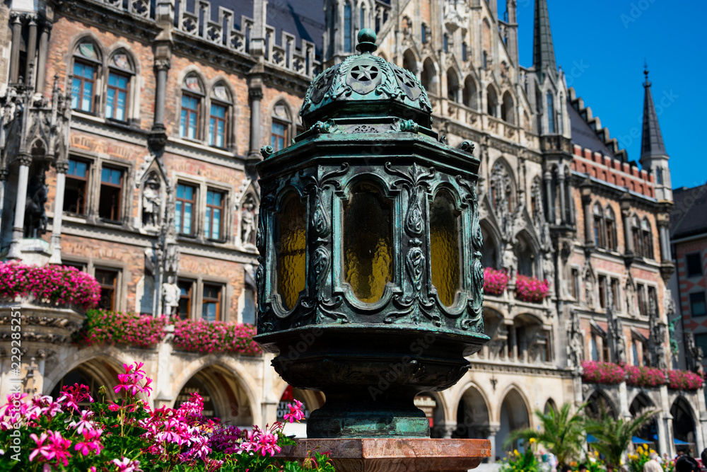 Old lamp with the New town hall (Neues Rathaus) in the background. Mary's Square (Marienplatz). Munich, Germany