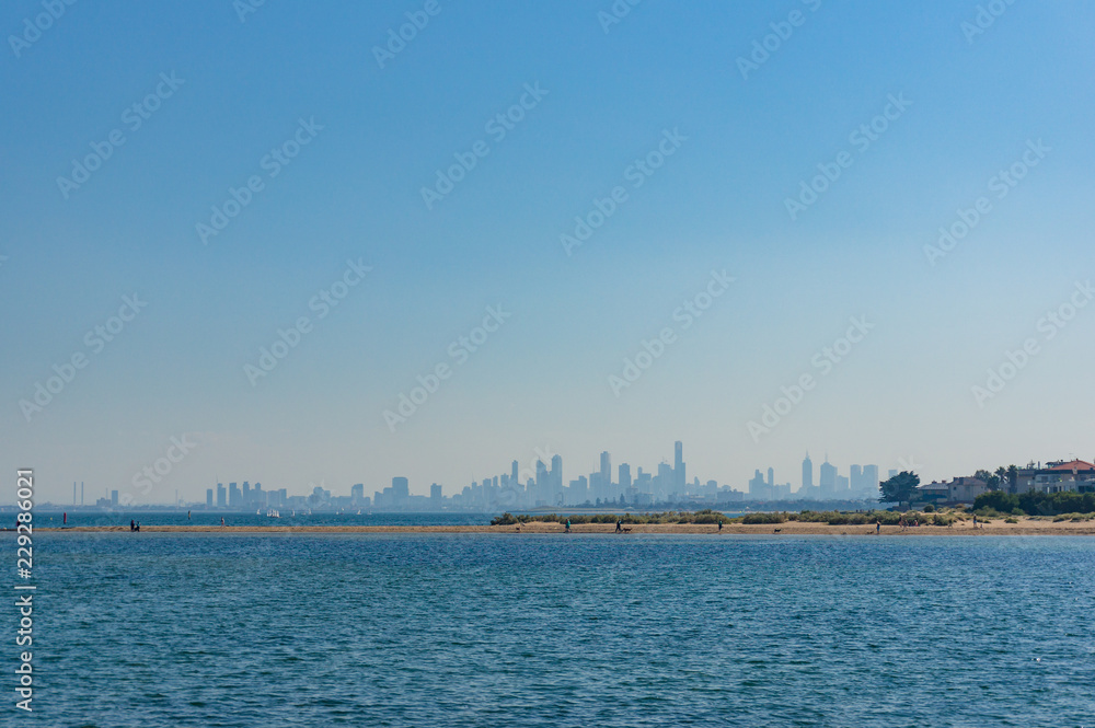 Blue ocean with cityscape with skyscrapers on the background