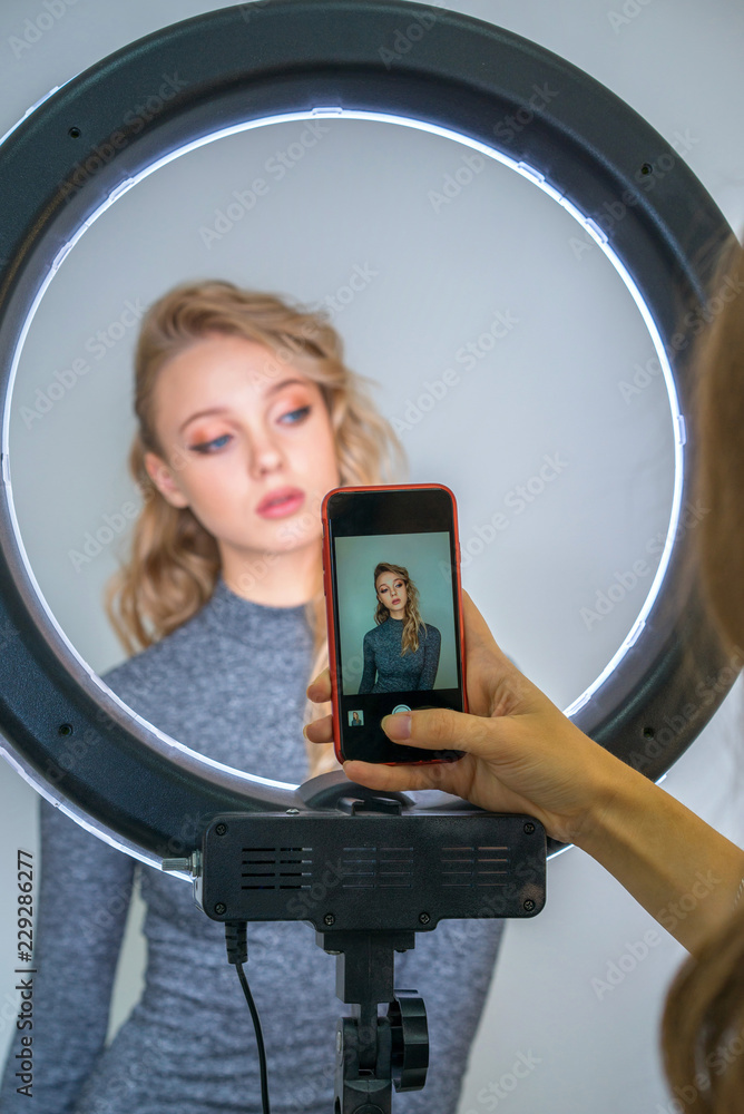 blonde girl posing in front of a mobile camera