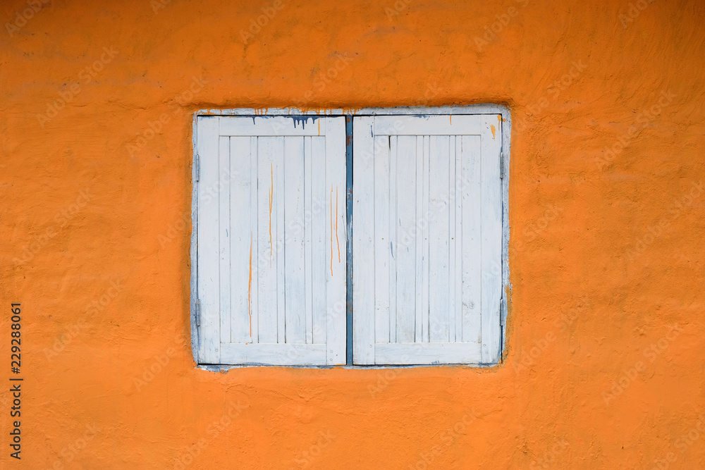 White wooden window on the orange background White wooden window on the orange background