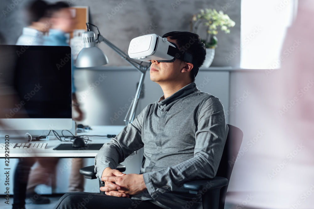 Businessman wearing VR in office Businessman wearing VR in office