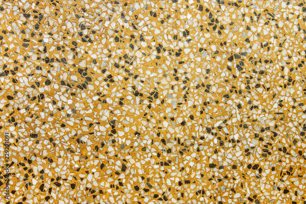 Texture colorful terrazzo floor in multicolored small rock patterns ,yellow , black and white background