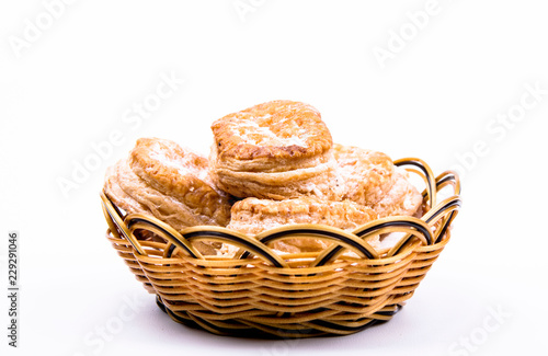 cookies in a basket isolated on white © Надежда Иванеева