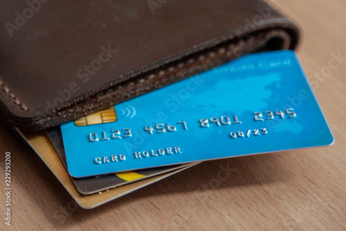 Credit cards in a wallet on wooden table. Open access for online shopping