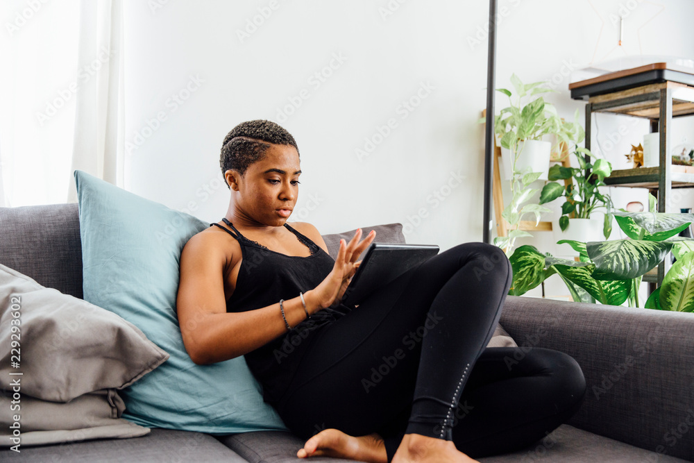 Woman At Home Playing On Tablet Woman At Home Playing On Tablet