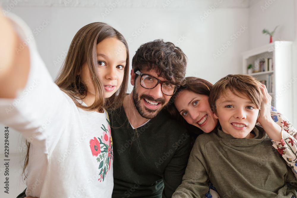 Daughter taking a selfie with her family at home. Daughter taking a selfie with her family at home.