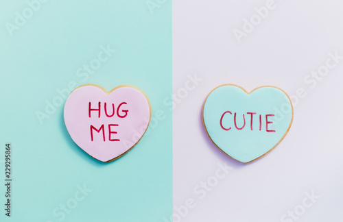 pale valentine candy cookies with messages over pastel background photo